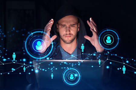 Handsome businessman in hoodie at workplace working with laptop to hire new employees for...