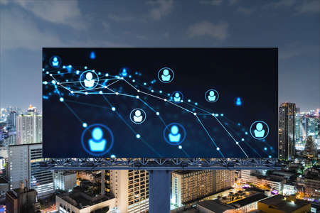 Glowing Social media icons on billboard over night panoramic city view of Bangkok. The concept of...