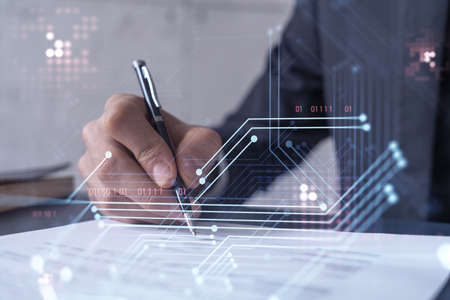 A client in dark blue suit is signing a contract to create a new software to present it in start up...