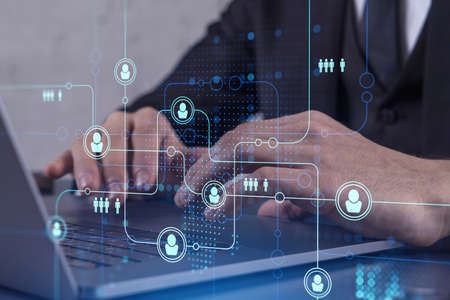 Hands of hr specialist is typing the keyboard in the internet to find the best candidates to create...