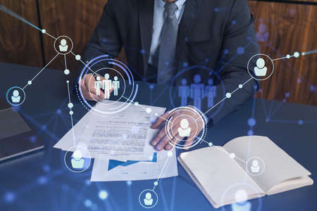 A potential employee in formal suit signing the contract to boost his career and gain new...
