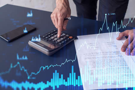 A trader computing historic data to predict stock market behavior. Internet trading concept. Forex...