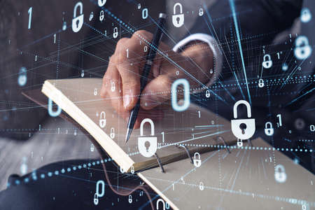 A programmer is taking notes of clients needs to protect cyber security from hacker attacks and save...