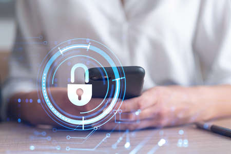 A woman programmer is browsing the Internet in smart phone to protect a cyber security from hacker...