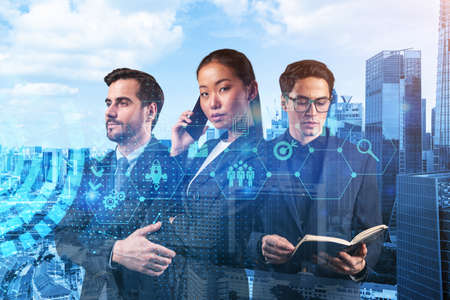 Group of business colleagues trying to find new tech approaches to solve problems at research and development department. Fintech hologram icons over Singapore background.の写真素材