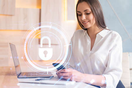 Attractive businesswoman in white shirt checking cyber security using smart phone to protect clients...