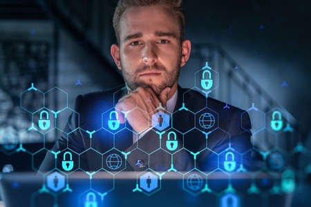 Portrait of handsome businessman thinking how to protect clients confidential information and cyber...