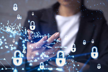 A woman programmer is browsing the Internet in smart phone to protect a cyber security from hacker...