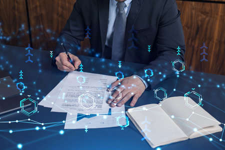 A client in dark blue suit is signing a contract to create a new software to present it in start up...