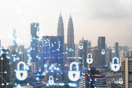 Hologram of padlock icons over panoramic city view of Kuala Lumpur to protect business, Malaysia, Asia. The concept of information security shields. Double exposure.の写真素材