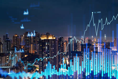 Stock market graph hologram, night panorama city view of Kuala Lumpur. KL is popular location to gain financial education in Malaysia, Asia. The concept of international research. Double exposure.の写真素材