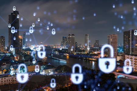 Glowing Padlock hologram, night panoramic city view of Bangkok, Southeast Asia. The concept of cyber security to protect companies. Double exposure.の写真素材