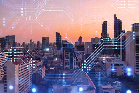 Glowing hologram of technological process, aerial panoramic cityscape of Bangkok at sunset. The...