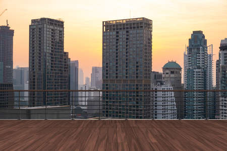 Panoramic Bangkok skyline view, wooden observatory deck on rooftop, sunset. Luxury Asian corporate and residential lifestyle. Financial city downtown, real estate. Product display mockup empty roofの写真素材
