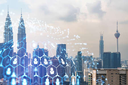 Social media icons hologram over panorama city view of Kuala Lumpur, Malaysia, Asia. The concept of...