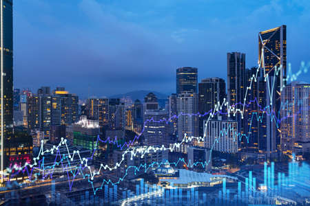 Stock market graph hologram, night panorama city view of Kuala Lumpur. KL is popular location to gain financial education in Malaysia, Asia. The concept of international research. Double exposure.の写真素材