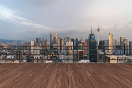 Panoramic Kuala Lumpur skyline view, wooden observatory deck on rooftop, sunset. Asian corporate and residential lifestyle. Financial city downtown, real estate. Product display mockup empty roofの写真素材