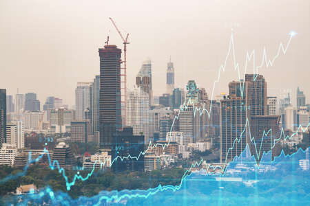 Forex and stock market chart hologram over panorama city view of Bangkok, the financial center in...