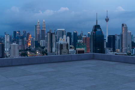 Panoramic Kuala Lumpur skyline view, concrete observatory deck on rooftop, night. Asian corporate...