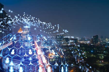 Glowing social media icons on night panoramic city view of Bangkok, Southeast Asia. The concept of...