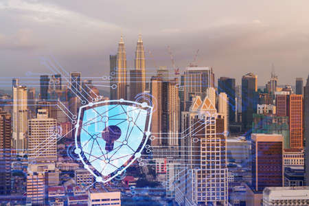 Padlock hologram on sunset panoramic cityscape of Kuala Lumpur, Malaysia, Asia. The concept of cyber...