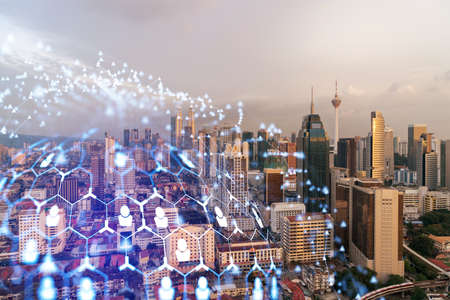 Hologram of social media icons over sunset panoramic cityscape of Kuala Lumpur, Malaysia, Asia. The concept of people connections and career opportunities in KL. Multi exposure.の写真素材