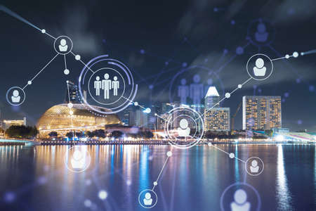 Glowing Social media icons on night panoramic city view of Singapore, Asia. The concept of...