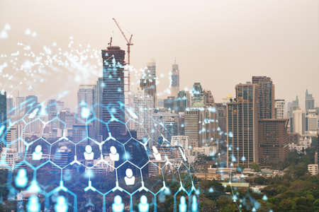 Social media icons hologram over panorama city view of Bangkok, Southeast Asia. The concept of people networking, connections and career opportunities. Double exposure.の写真素材