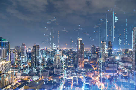 FOREX graph hologram, aerial night panoramic cityscape of Bangkok, the developed location for stock market researchers in Southeast Asia. The concept of fundamental analysis. Double exposure.の写真素材