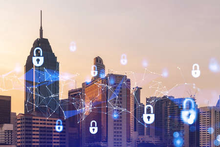 Padlock hologram on sunset panoramic cityscape of Kuala Lumpur, Malaysia, Asia. The concept of cyber...