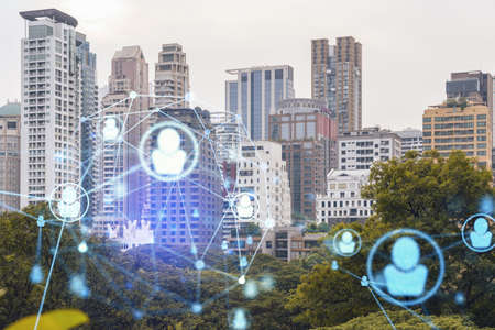 Social media icons hologram over panorama city view of Bangkok, Southeast Asia. The concept of people networking, connections and career opportunities. Double exposure.の写真素材
