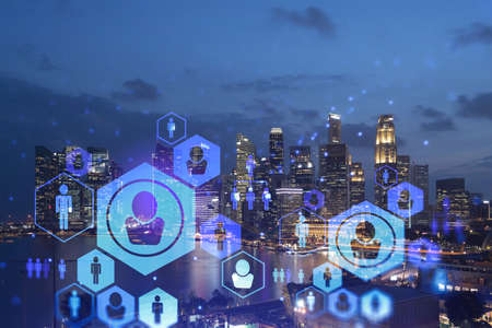 Glowing Social media icons on night panoramic city view of Singapore, Asia. The concept of...