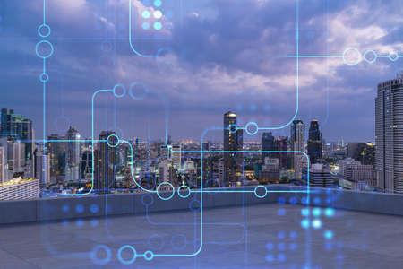 Rooftop with concrete terrace, Bangkok night skyline. Hi tech digital holograms to optimize business process by applying new technologies. City downtown. Double exposure.の写真素材