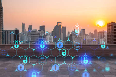 Rooftop with wooden terrace, Bangkok sunset skyline. Cyber security concept to protect clients confidential information. IT hologram padlock icons. City downtown. Double exposure.の写真素材