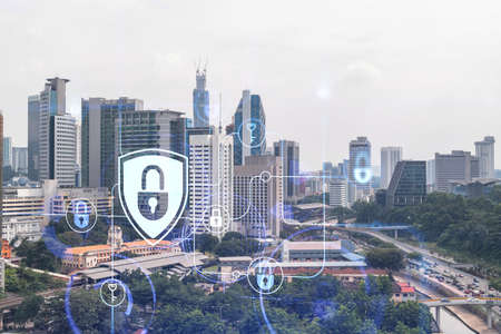 Hologram of padlock icons over panoramic city view of Kuala Lumpur to protect business, Malaysia,...