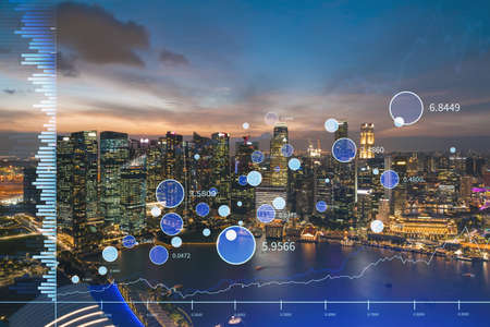Stock market graph hologram, night panorama city view of Singapore, popular location to gain...