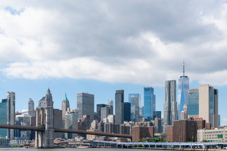 Brooklyn bridge with New York City Manhattan financial downtown skyline panorama at day time over...
