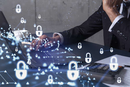 A programmer is typing a code on computer to protect a cyber security from hacker attacks and save...