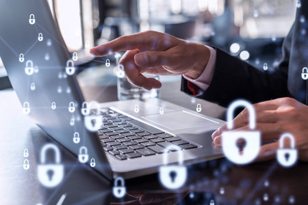 A programmer is typing a code on computer to protect a cyber security from hacker attacks and save clients confidential data. Padlock Hologram icons over the typing hands. Formal wear.の写真素材