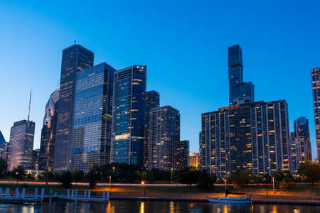 A picturesque view of Downtown skyscrapers of Chicago skyline panorama over Lake Michigan at night time, Chicago, Illinois, USAの写真素材