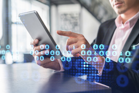 Businessman in suit using tablet device to check new candidates for international business...