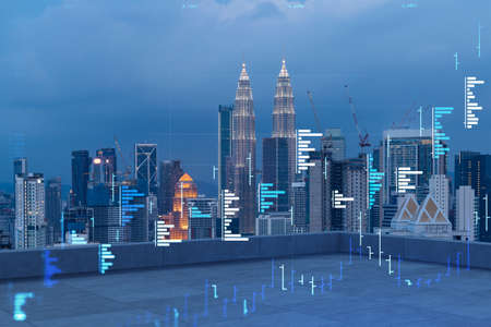 Rooftop with concrete terrace, Kuala Lumpur night skyline. Forecasting and business modeling of financial markets hologram digital charts. City downtown. Double exposure.の写真素材