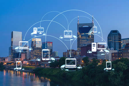 Panoramic view of Broadway district of Nashville over Cumberland River at illuminated night skyline,...