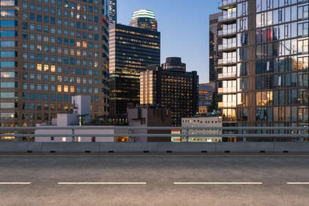 Empty urban asphalt road exterior with city buildings background. New modern highway concrete construction. Concept of way to success. Transportation logistics industry fast delivery. Los Angeles. USA.の写真素材