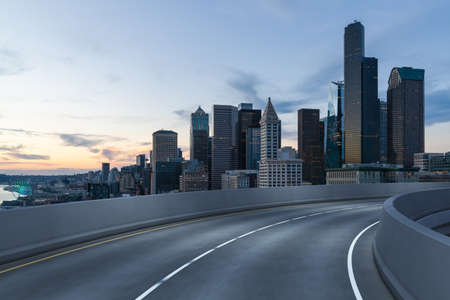 Empty urban asphalt road exterior with city buildings background. New modern highway concrete construction. Concept way to success. Transportation logistics industry fast delivery. Seattle. USA.の写真素材
