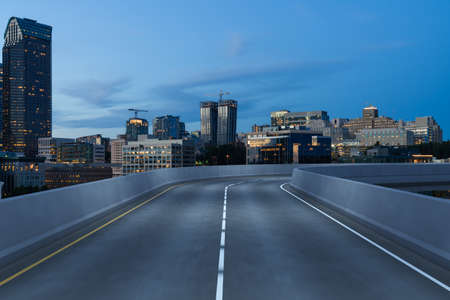 Empty urban asphalt road exterior with city buildings background. New modern highway concrete...