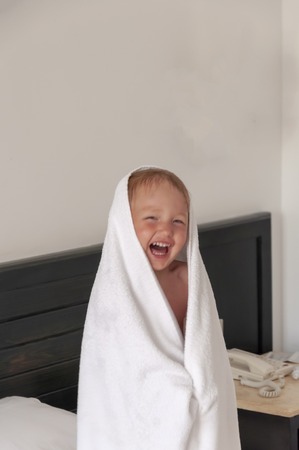 The little girl in the towel is smiling.の写真素材