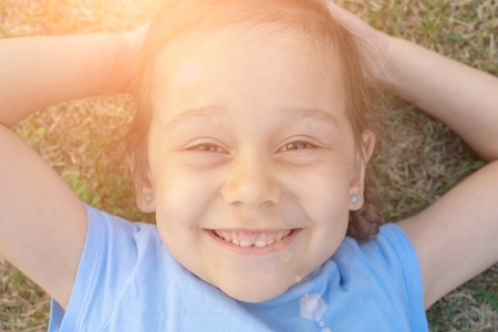 Close-up summer portrait of young girl. 5 years old kid smilingの写真素材