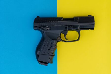 Close up image of pistol on a multicolored