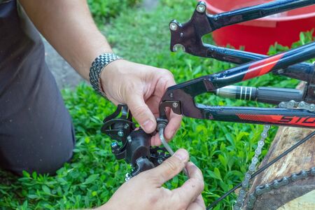 Russia, Tatarstan, July 13, 2019. Bike repair Young man repairing bike in the forest